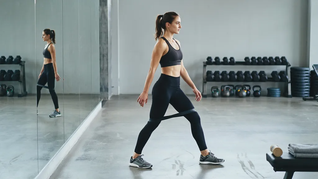 Woman performing resistance band lateral walks.