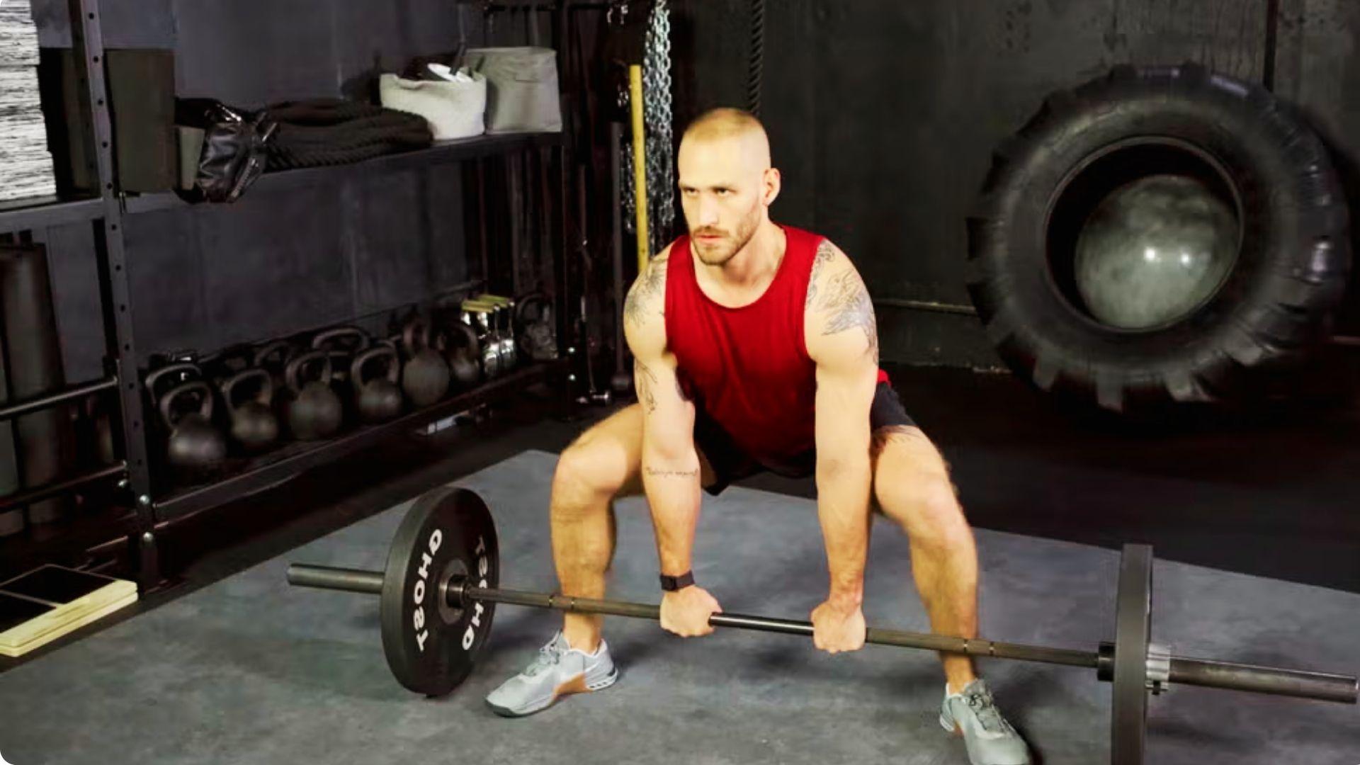 Athlete performing a sumo deadlift with a wide stance and barbell, emphasizing the glutes, hamstrings, and inner thighs.