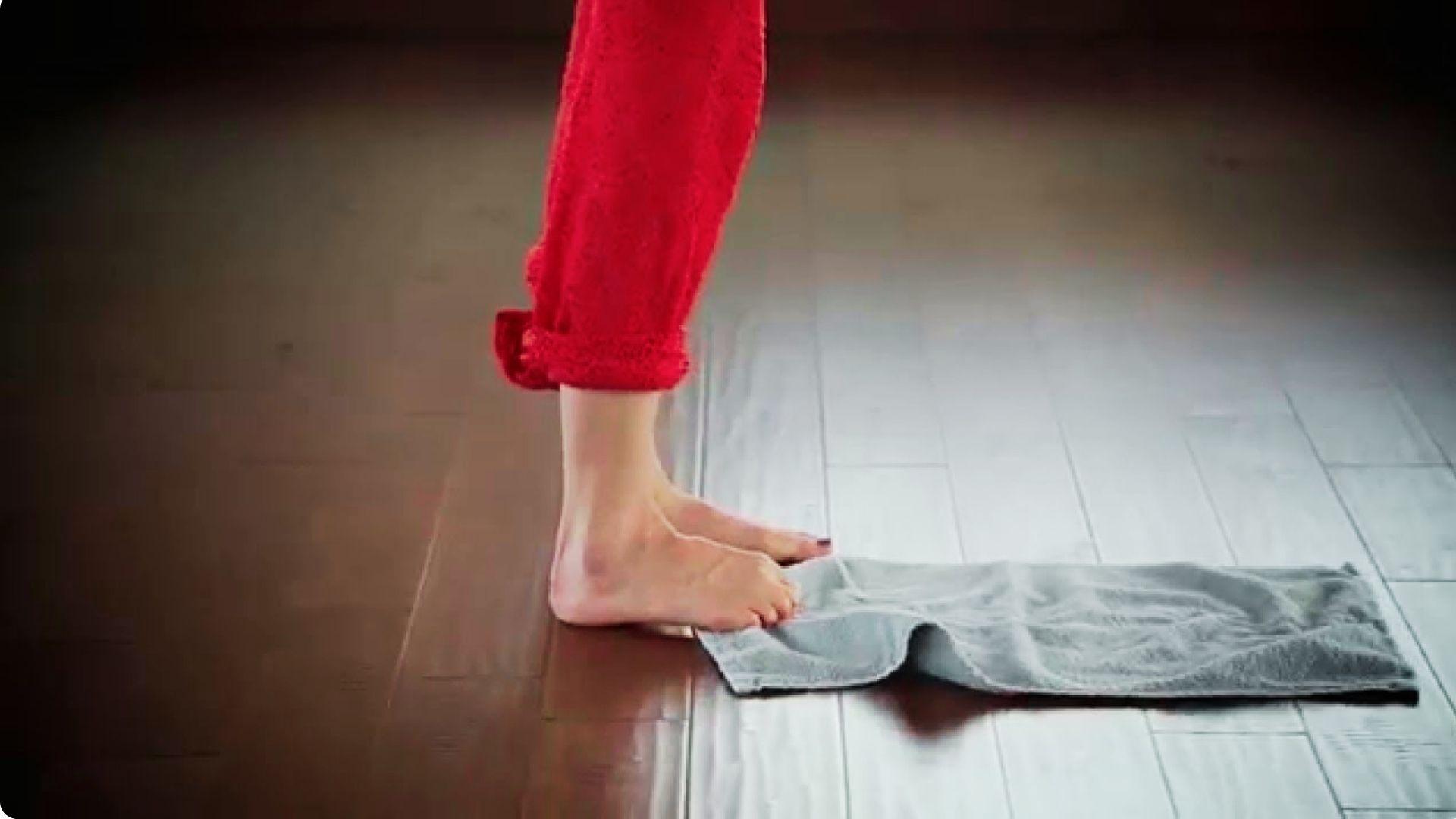 A person doing Toe curls with towel exercise strengthening small foot muscles