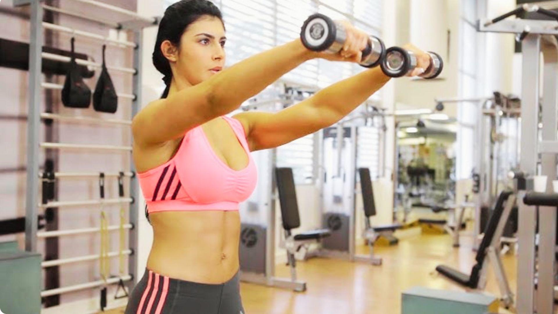 Front raise exercise with dumbbells focusing on anterior shoulder muscles