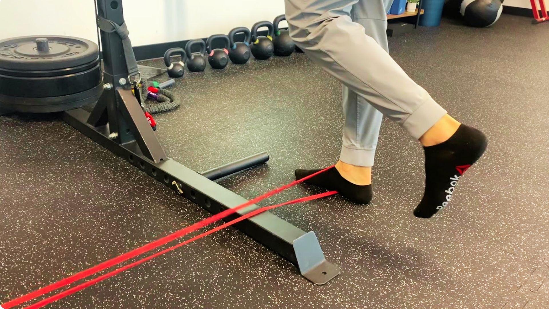 Single-leg heel raise exercise for ankle strength, balance, and stability in the gym.
