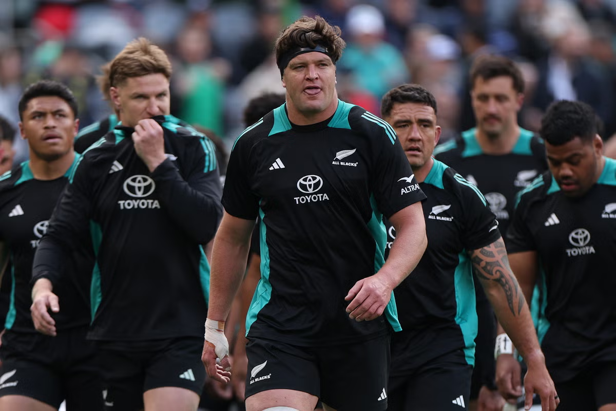 The All Blacks rugby team walks onto the field, showcasing their iconic black uniforms and determined expressions.