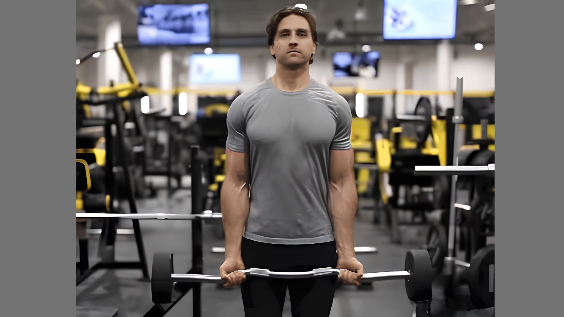 A man performing a barbell curl with a wavy EZ-bar inside a gym.